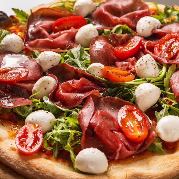 Βάση με σάλτσα ντομάτας με Bresaola | Baby ρόκα | Φρέσκια μοτσαρέλα Bufala | Ντοματίνια | Έξτρα παρθένο ελαιόλαδο